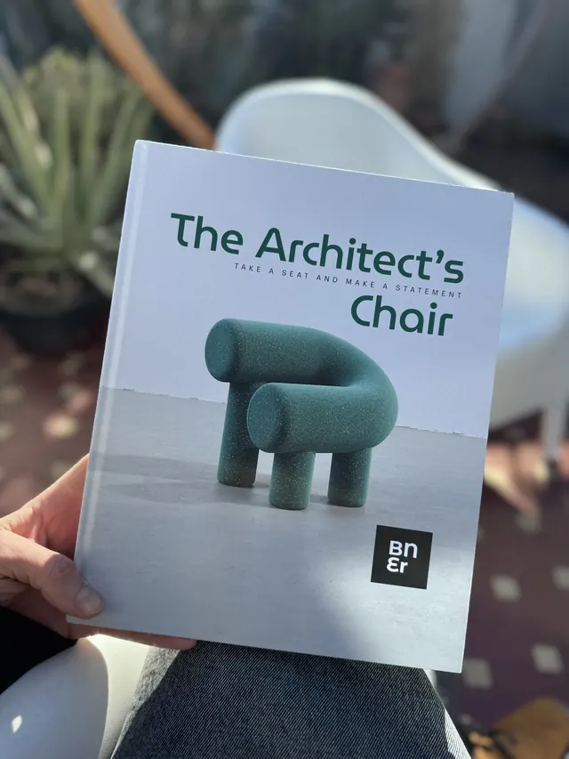 The Architect’s Chair 01 held in one hand on a sunny terrace