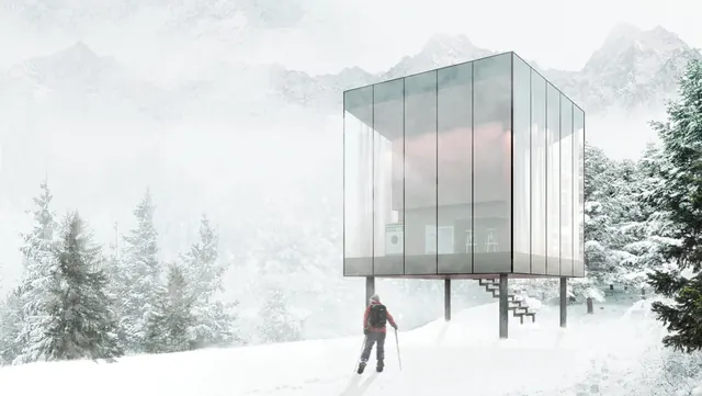 The glass cabin on stilts in the snow, a hiker walking up to it through the pines