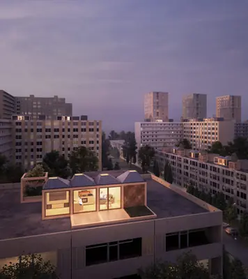 A small box with a lit glass front on a flat roof among apartment towers at dusk