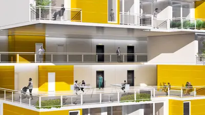 A cutaway of a tower with small yellow homes and shared balconies full of people