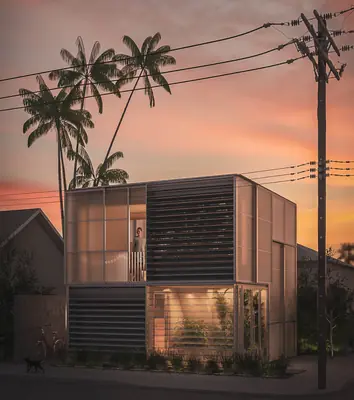 A two-storey box of translucent panels and louvres at sunset, palm trees and power lines behind