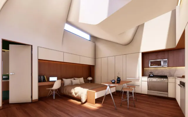 The one room: a bed, a desk and a kitchen under a skylight