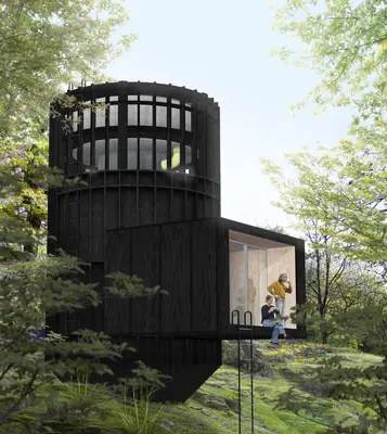 A black round timber tower in a green wood, a room sticking out at its foot