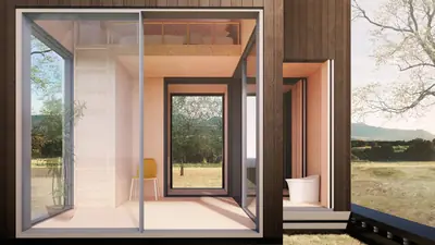 Looking through a pale timber room with glass on two sides to a dry landscape