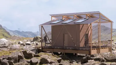 A timber cabin with a glass roof on stilts among rocks in a mountain valley