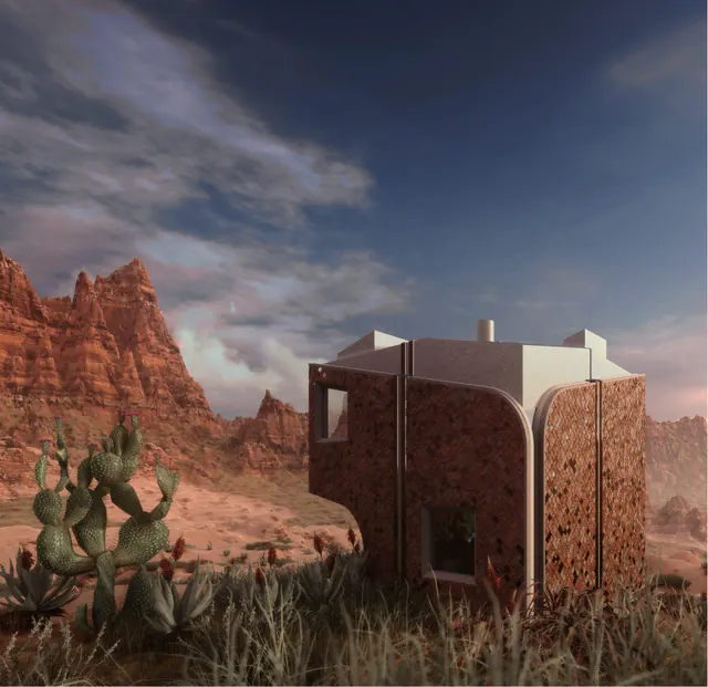 The house among cacti and dry grass below red cliffs: a cube with rounded corners and patterned brown panels