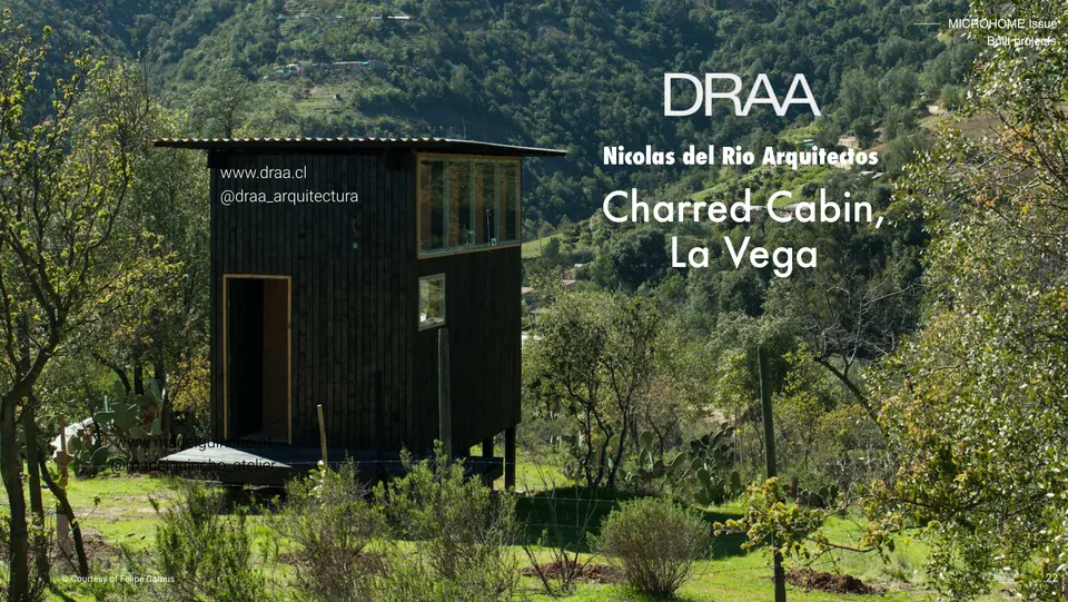 Charred Cabin, La Vega: a black cabin on stilts in green hills, with its title