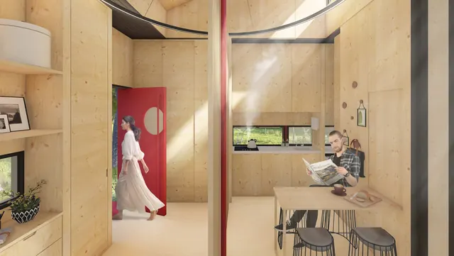 Inside: pale timber walls, a woman walking through a red door, a man reading at a table by the window