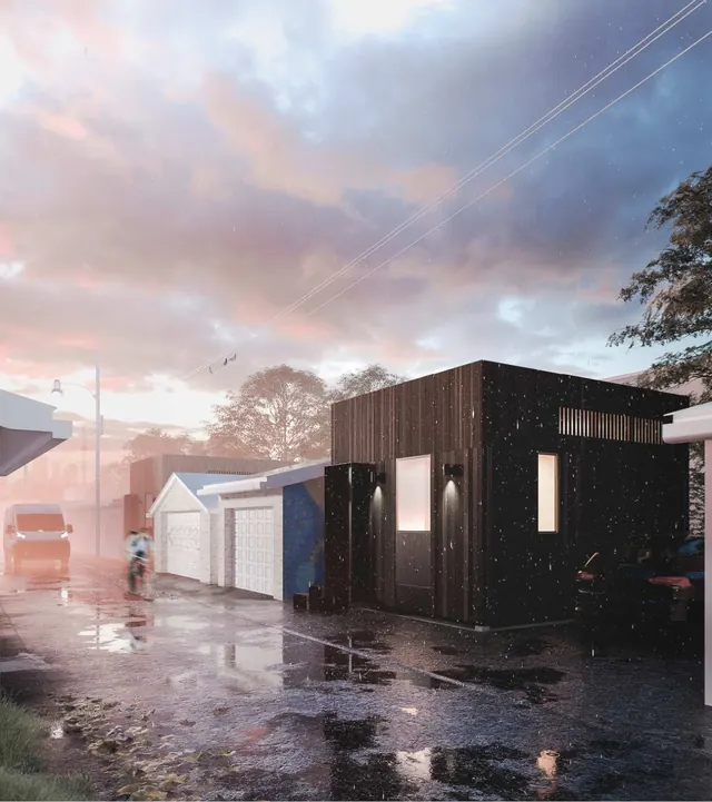 The Carve House at dusk: a small dark timber house at the end of a wet laneway, garages and a red van beside it
