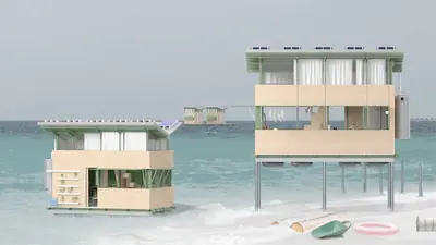 Two timber homes on steel legs in the shallow sea, solar panels on their roofs