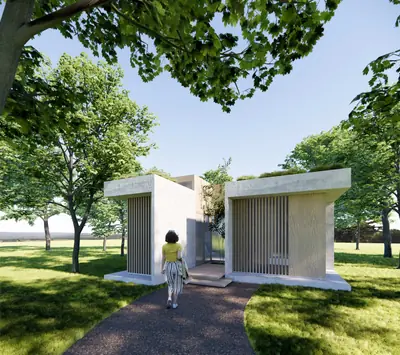 Two small white pavilions facing each other under trees, a woman walking between them