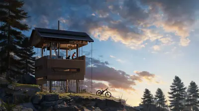 A dark timber tower house on a hilltop at sunset, a bicycle beside it