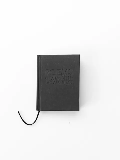 The notebook alone on a large white table, showing how small it is