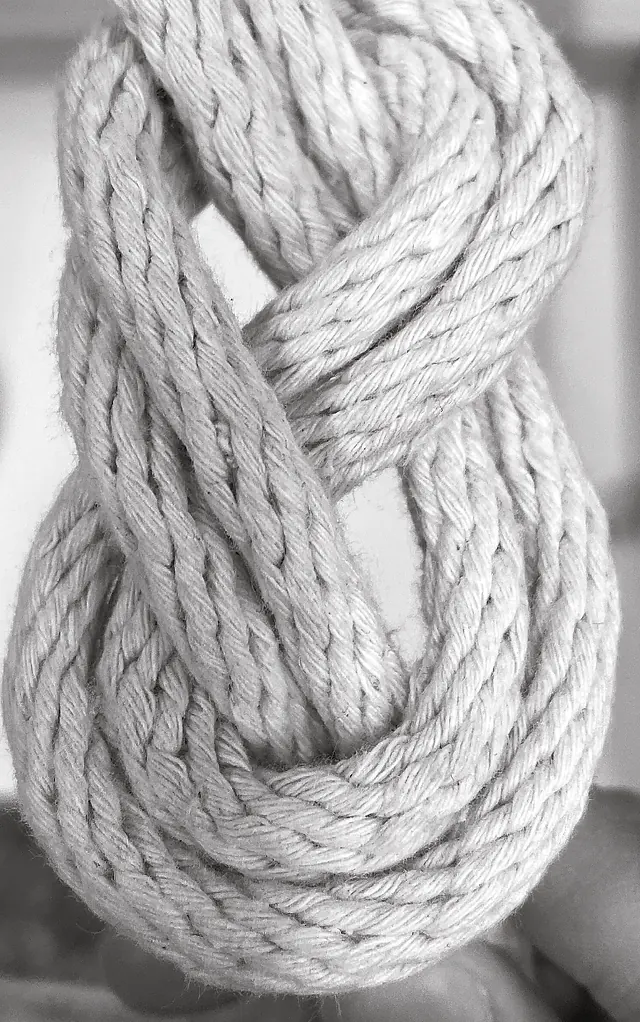 Black and white close-up of a thick rope knot