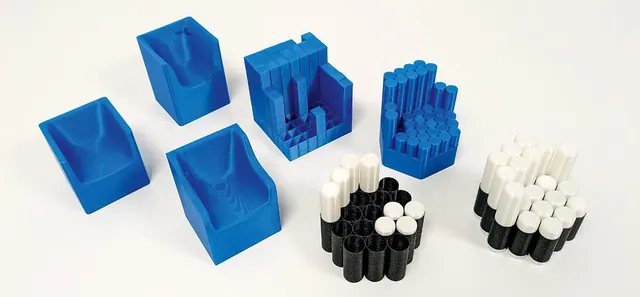 Blue 3D-printed frame parts and black and white noodle modules of the Noodle Chair