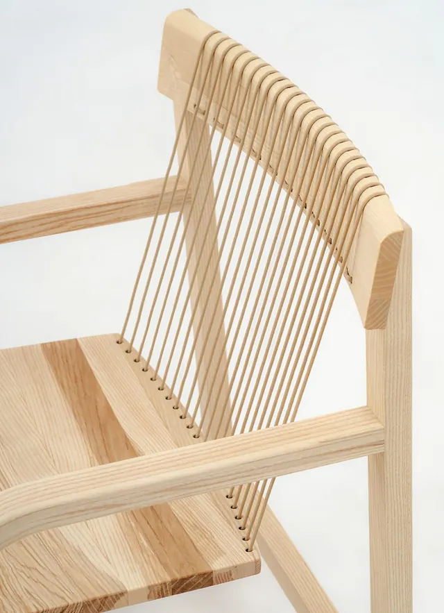 A PONTUM chair in ash, its back strung with vertical paracord