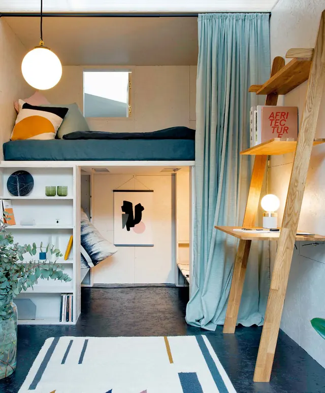 Inside The Shed: a raised bed, shelves, a desk on a ladder and a curtain