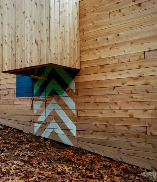 Motivos en V azules y verdes pintados en las tablas de madera de la torre
