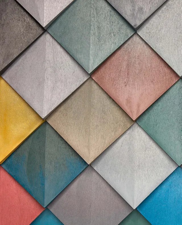 A close-up of the recycled plastic tiles in pink, green, blue and grey