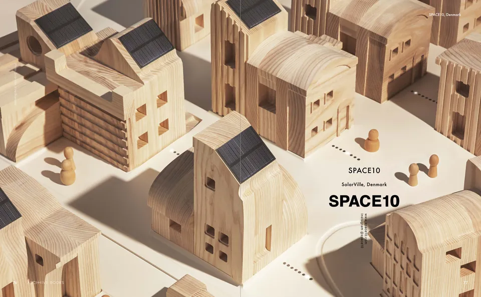A wooden model village of little timber houses with solar panels on their roofs